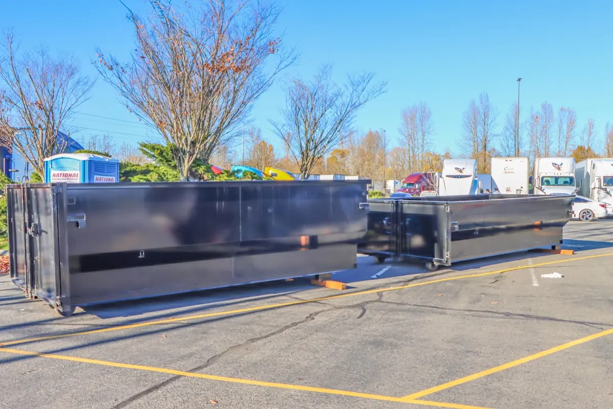 Professional dumpster rental service with roll-off container on residential driveway in Delta